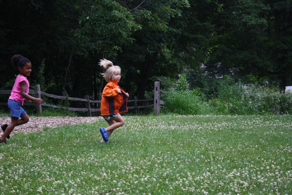 kids running clover field
